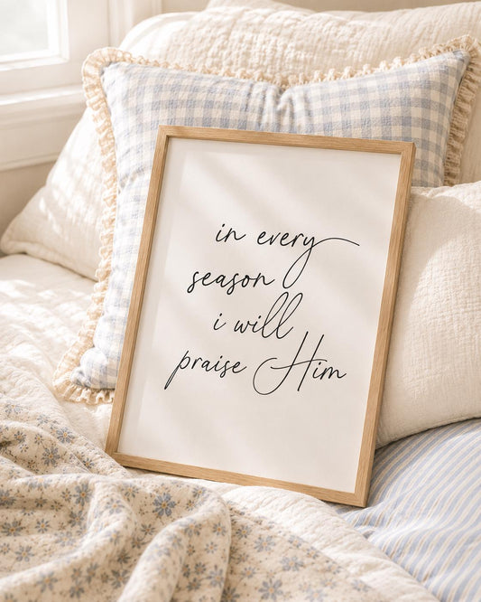 In Every Season I Will Praise You English Christian art print with black script lettering in a light wooden frame