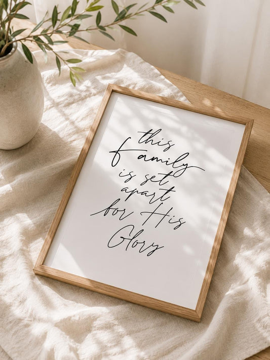 This Family Is Set Apart for His Glory English Christian art print with black script lettering in a light wooden frame