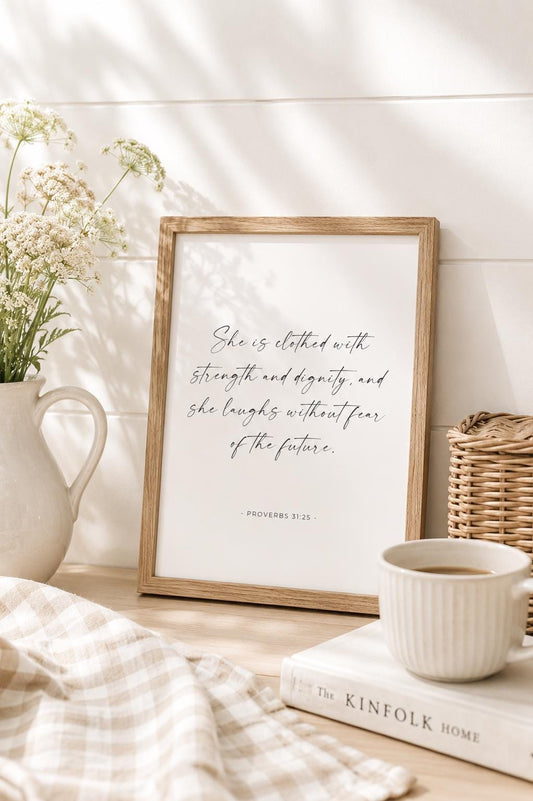 She Is Clothed with Strength Proverbs 31:25 English Christian art print with black script lettering on a white background